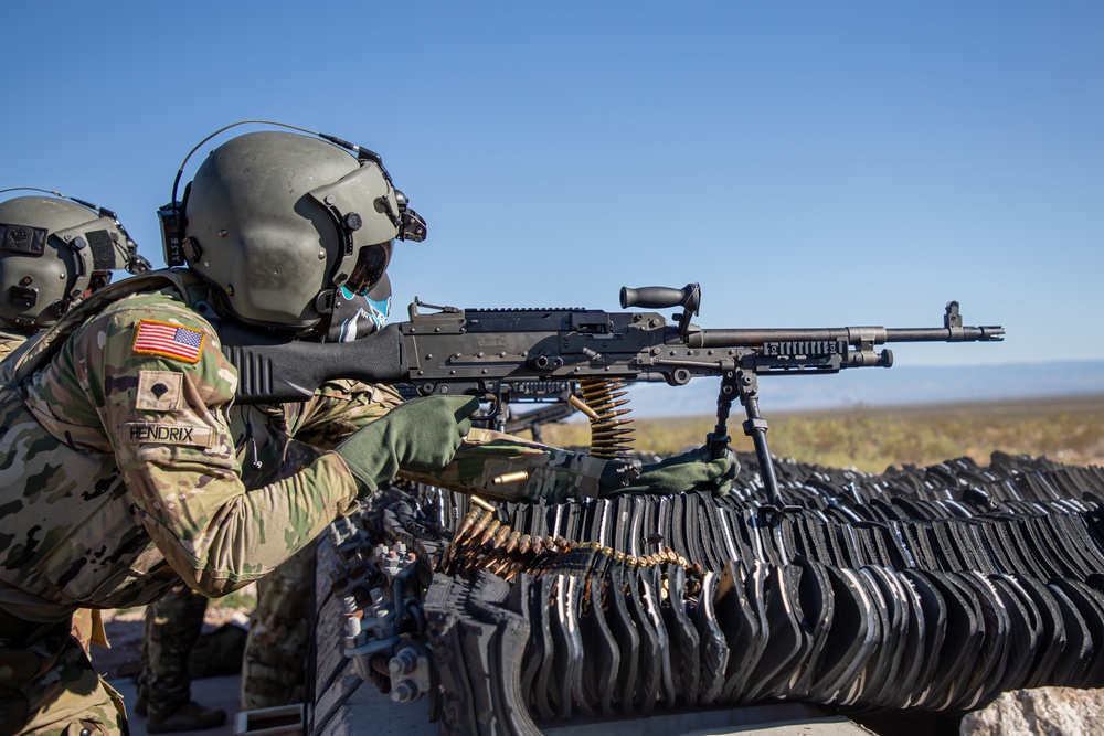 U.S. Army Door Gunner fires a M240B