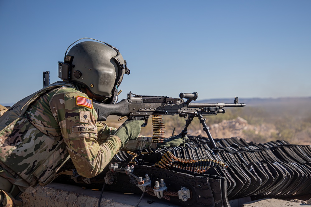 U.S. Army Door Gunner fires a M240B