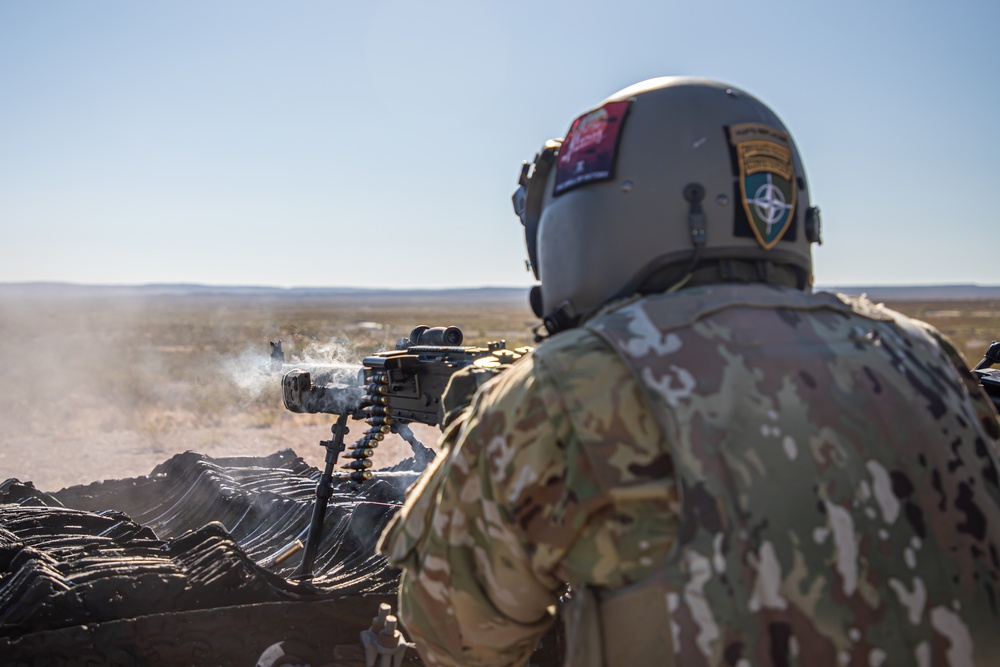 U.S. Army Door Gunner fires a M240H