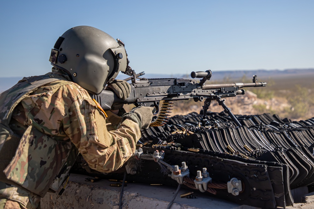 U.S. Army Pilot fires a M240B