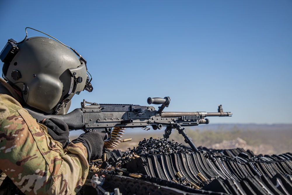 U.S. Army Door Gunner fires a M240B