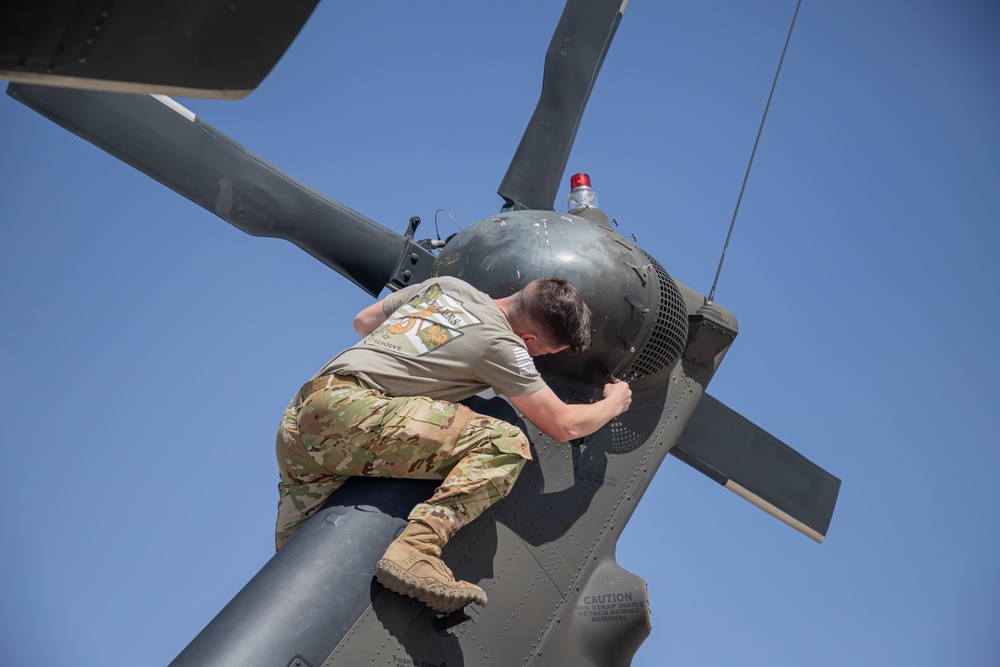 U.S. Army Door Gunner conducts pre-flight checks