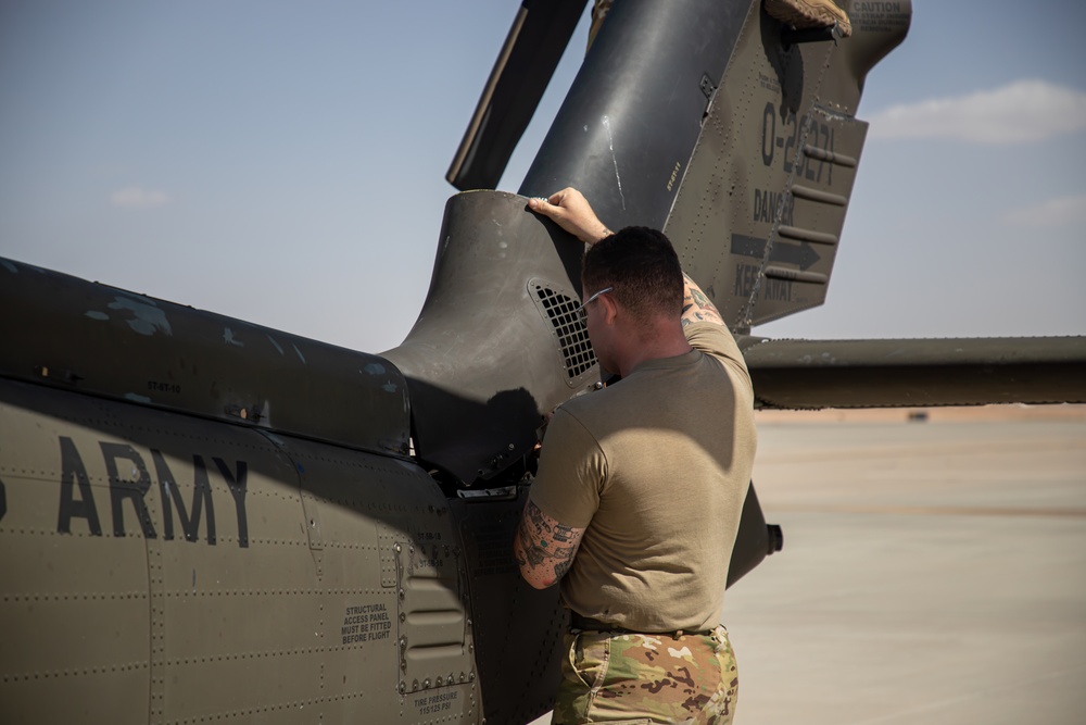 U.S. Army Door Gunner conducts pre-flight checks