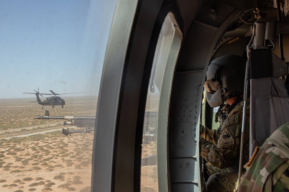 U.S. Army Door Gunner scans the desert