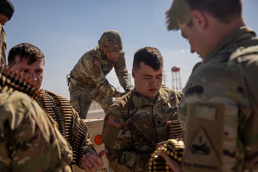 U.S. Army UH-60M Blackhawk crews grab ammunition