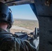 U.S. Army Door Gunner prepares to fire at target