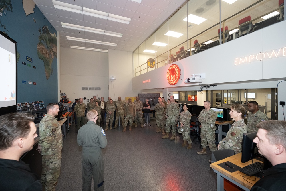 U.S. Air Force Capt. Justin Niquette, center right, 60 Air Mobility Wing Phoenix Spark Lab directorDepartment of the Air Force California Installation Commanders' Caucus attendees are briefed on Phoenix Spark lab capabilities.