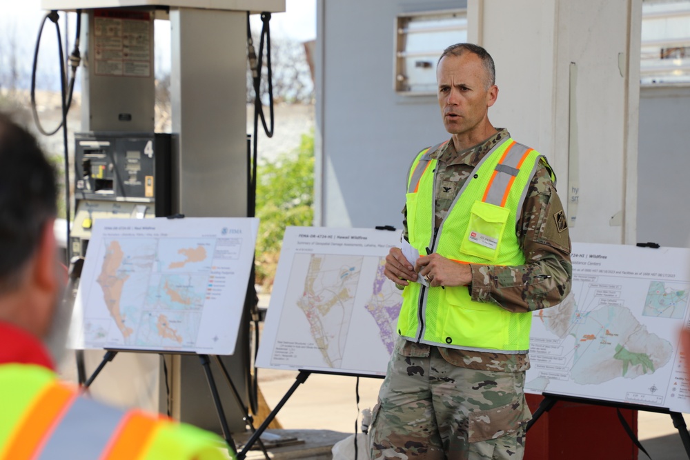 Col. Eric Swenson briefs visitors during Lahaina site visit