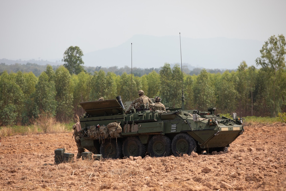 Soldiers wait for orders atop M1129