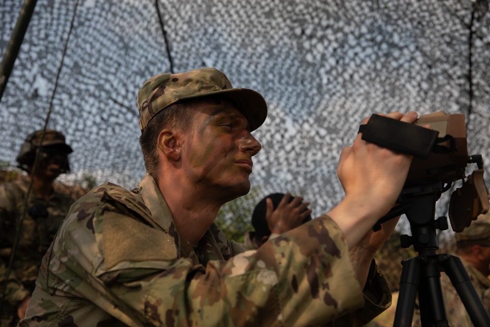 Pvt. Bray waits observes mortar rounds on hills