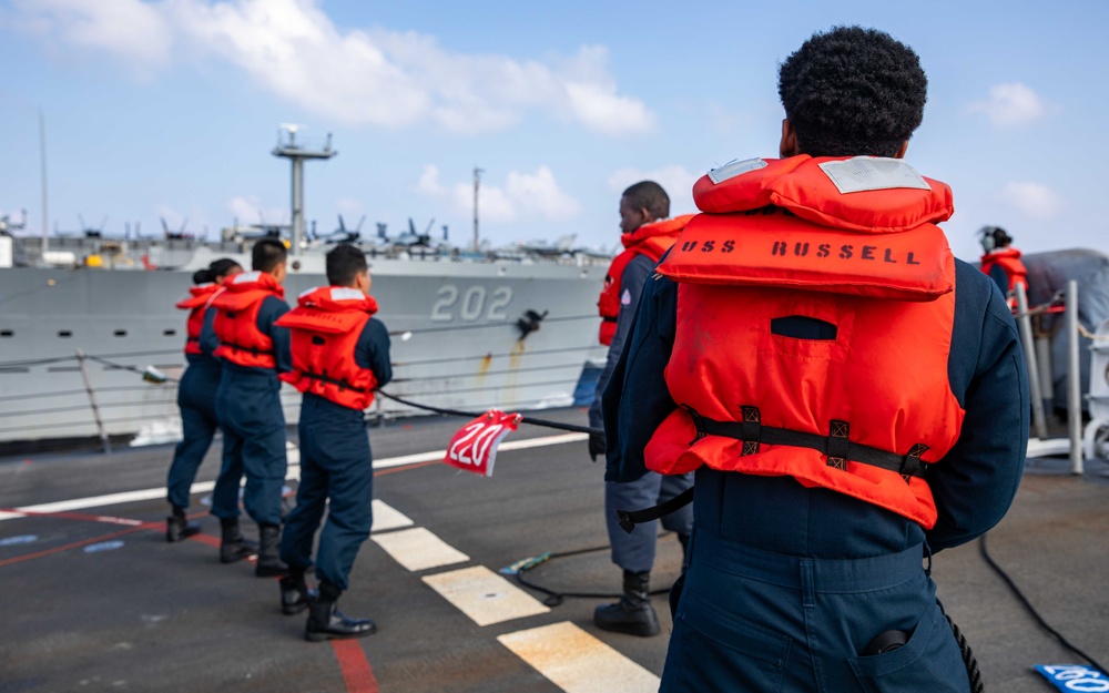 USS Russell (DDG 59) refuels alongside USS Theodore Roosevelt (CVN 71)