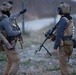 Georgian and Romanian special operations forces soldiers discuss security tactics during a STX with U.S.MARSOC Marines during Trojan Footprint 24