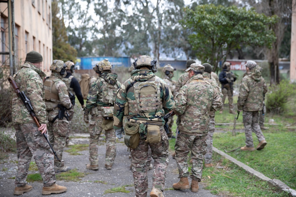 U.S. MARSOC Marines, Georgian, and Spanish special operations forces soldiers move to start their training mission during Trojan Footprint 24