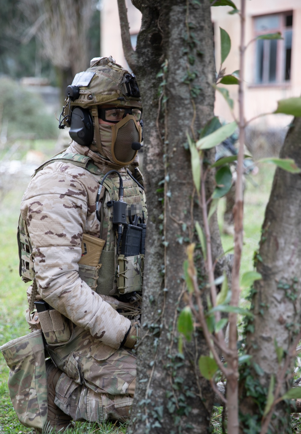 A Spanish special operations forces soldier waits patiently to clear a compound during Trojan Footprint 24