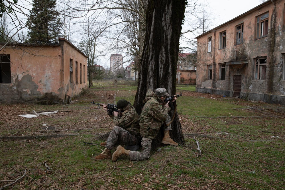 Georgian special operations forces soldiers maintain security outside a compound during Trojan Footprint 24