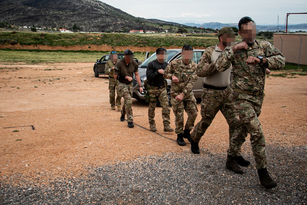 Greek SOF soldiers and Green Beret progress through raid mission rehearsals