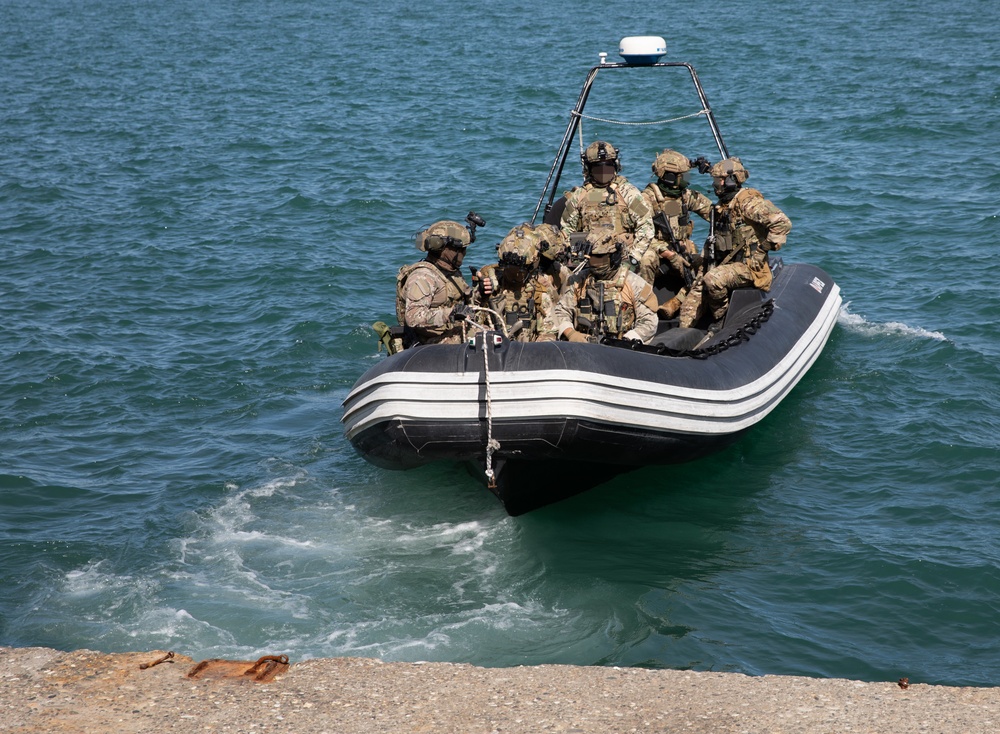 Georgian and Spanish special operations forces soldiers push off from the dock after executing a visit, board, search, and seizure operation during Trojan Footprint 24