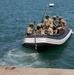 Georgian and Spanish special operations forces soldiers push off from the dock after executing a visit, board, search, and seizure operation during Trojan Footprint 24