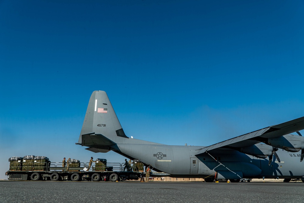 Airmen load AFCENT C-130s with humanitarian aid bound for Gaza