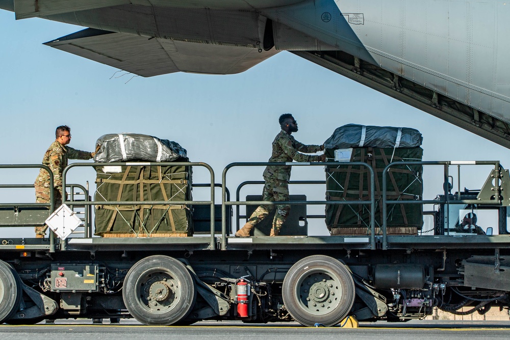 Airmen load AFCENT C-130s with humanitarian aid bound for Gaza