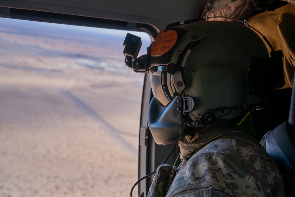 U.S. Army Crew Chief scans the desert