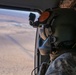 U.S. Army Crew Chief scans the desert