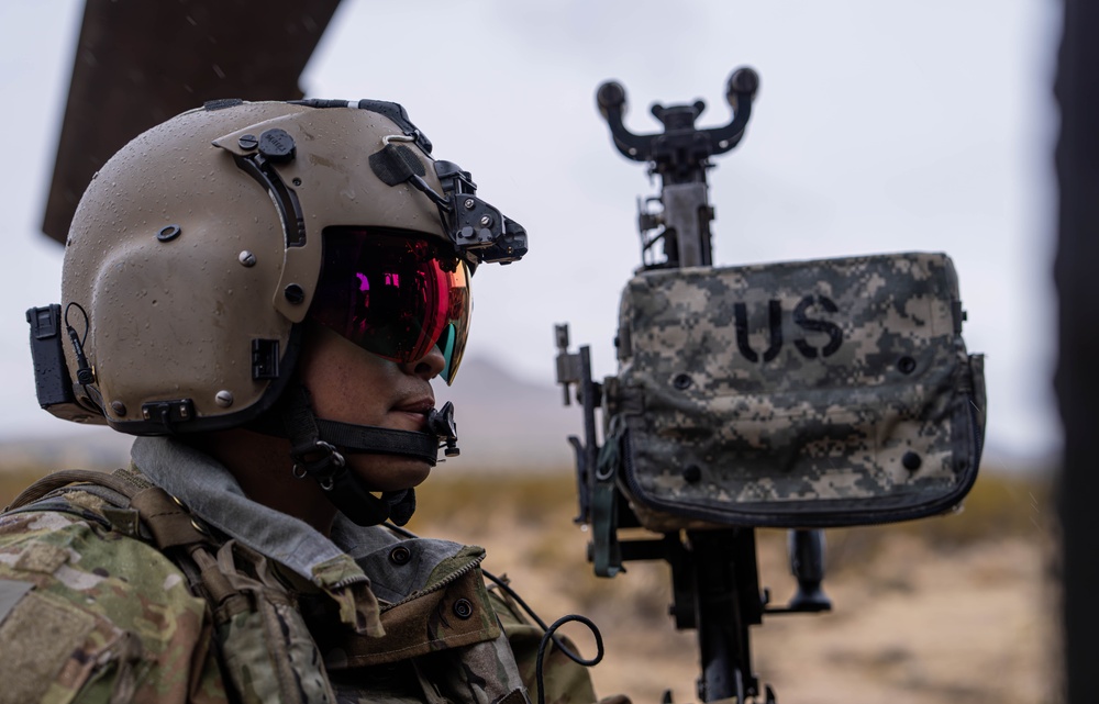 U.S. Army Door Gunner conducts pre-flight checks