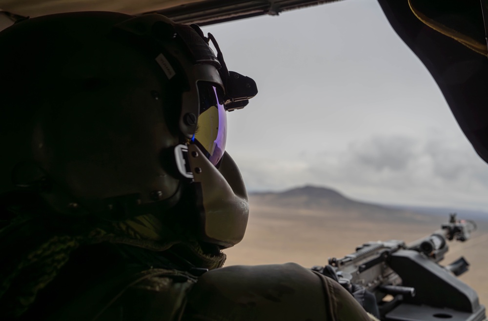 U.S. Army Crew Chief scans the desert