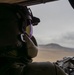 U.S. Army Crew Chief scans the desert