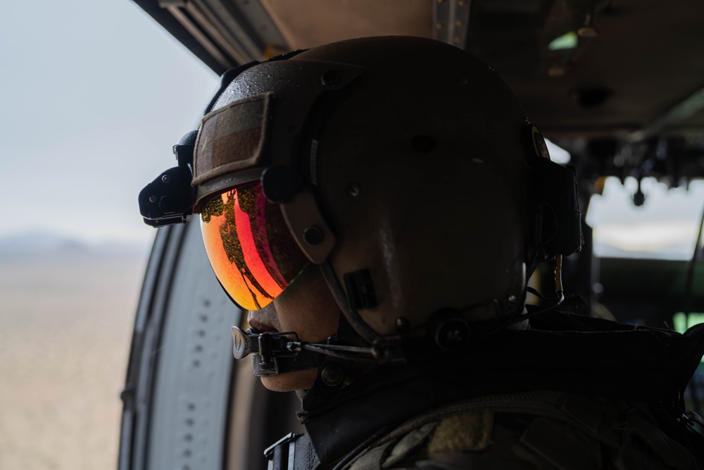 U.S. Army Door Gunner scans the desert