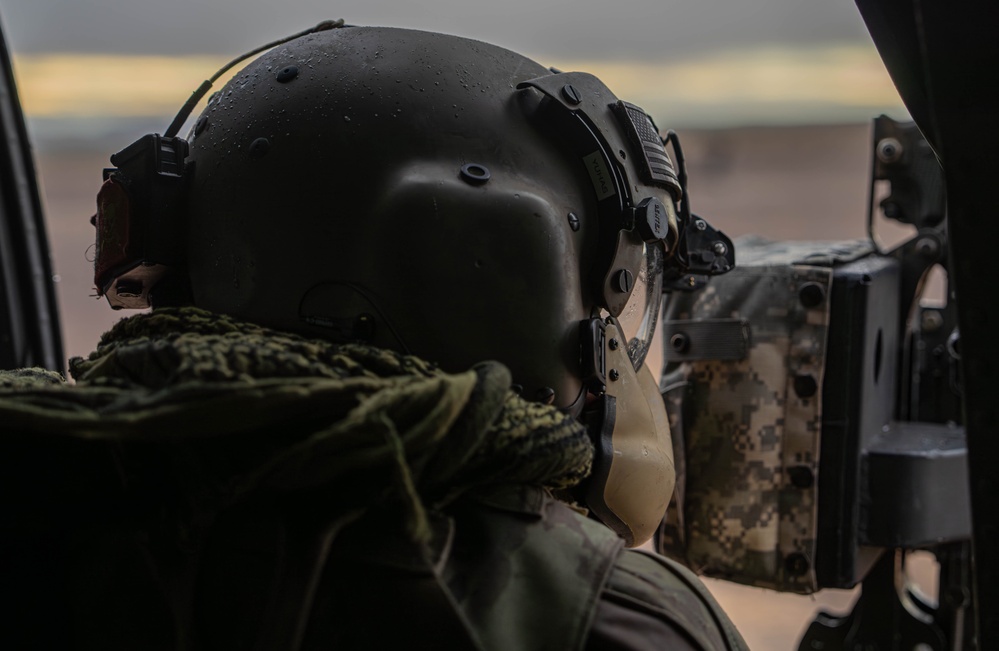 U.S. Army Crew Chief scans the desert