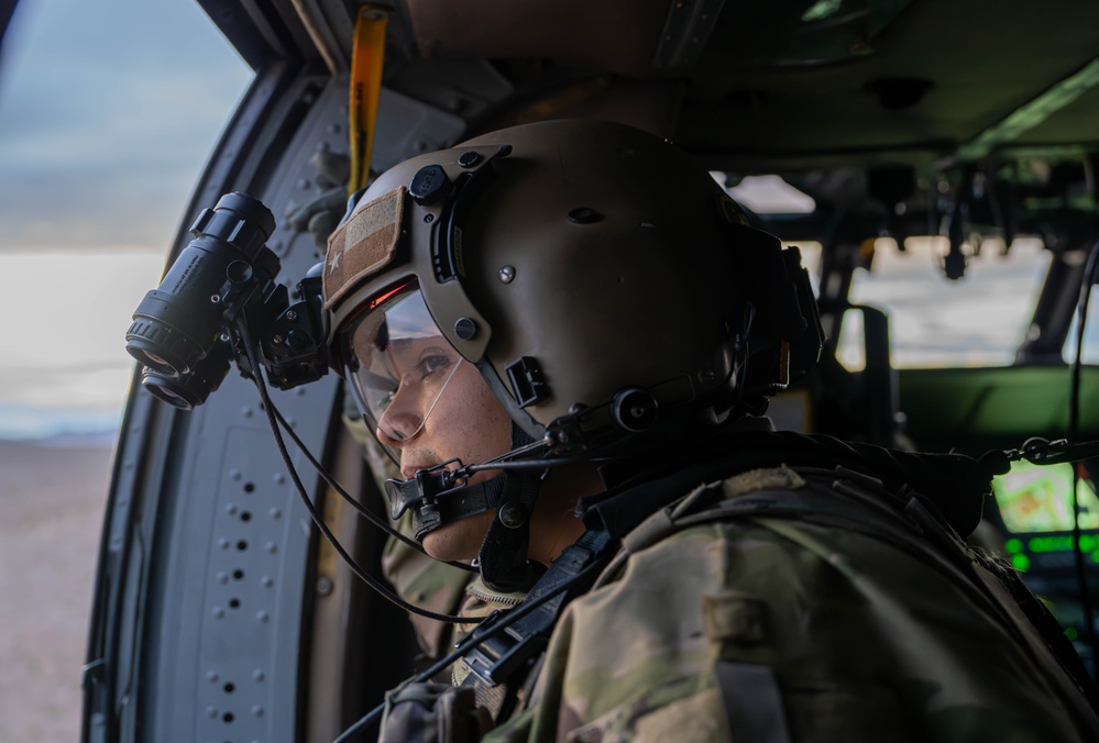 U.S. Army Door Gunner scans desert