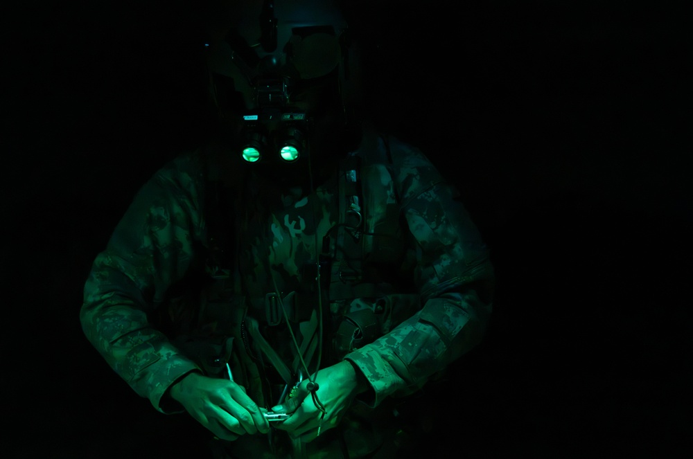 U.S. Army Crew Chief conducts pre-flight checks