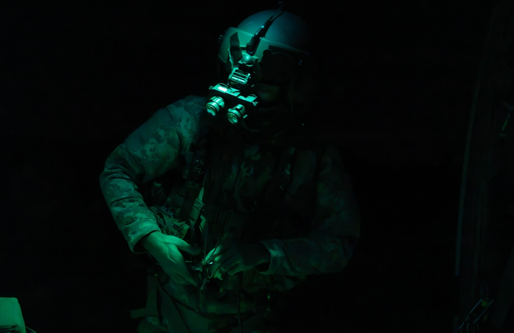 U.S. Army Crew Chief conducts pre-flight checks