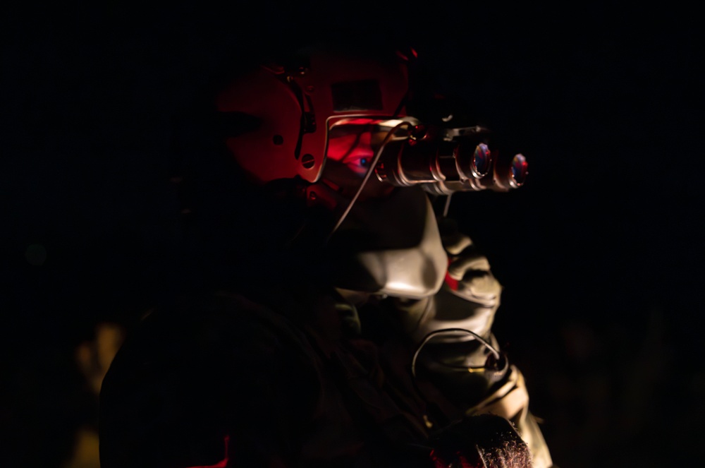 U.S. Army Flight Medics checks his night vision goggles
