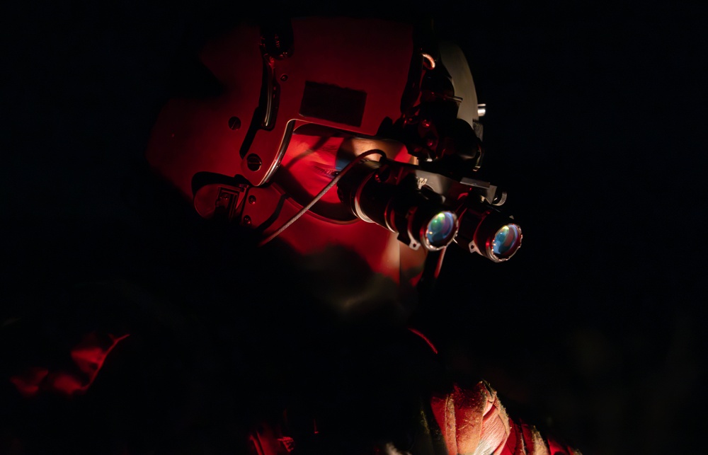 U.S. Army Flight Medics checks his night vision goggles