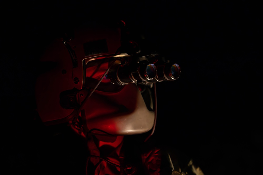 U.S. Army Flight Medics checks his night vision goggles
