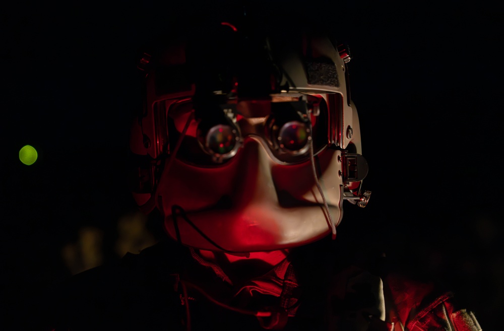 U.S. Army Flight Medics checks his night vision goggles