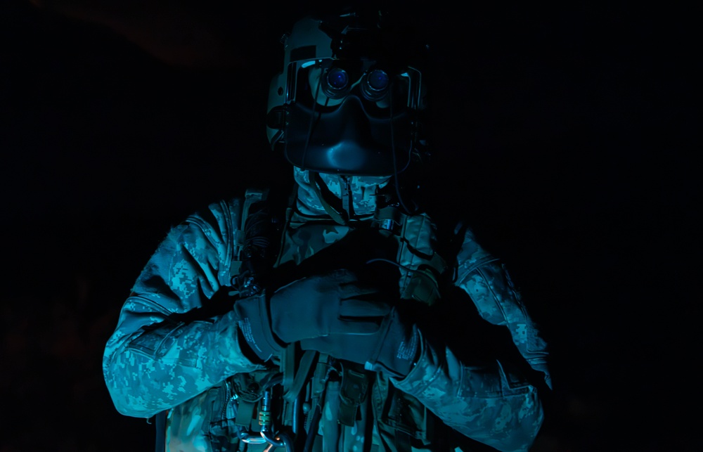 U.S. Army Crew Chief conducts pre-flight checks
