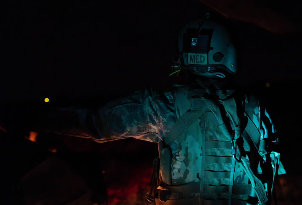 U.S. Army Crew Chief conducts pre-flight checks