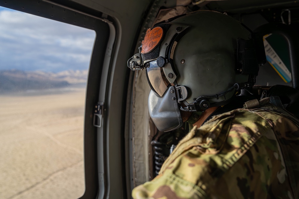 U.S. Army Crew Chief scans the desert