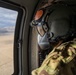 U.S. Army Crew Chief scans the desert