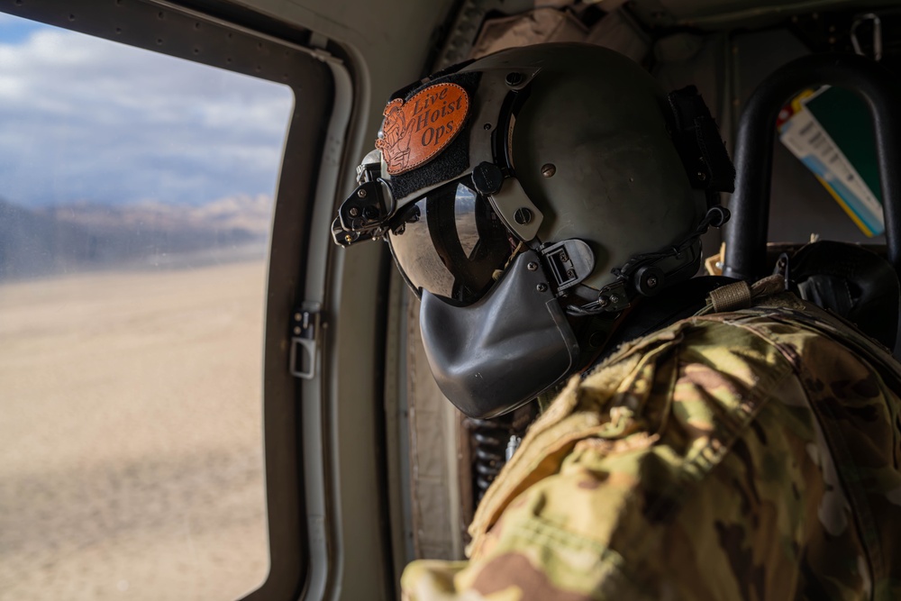 U.S. Army Crew Chief scans the desert