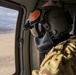 U.S. Army Crew Chief scans the desert