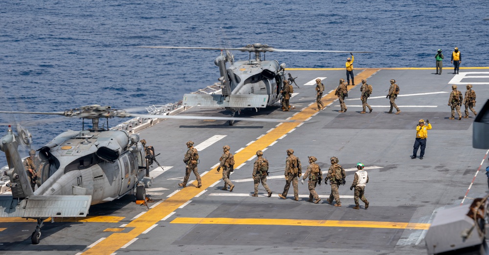 Marines board MH-60S Sea Hawk helicopters on USS America (LHA )