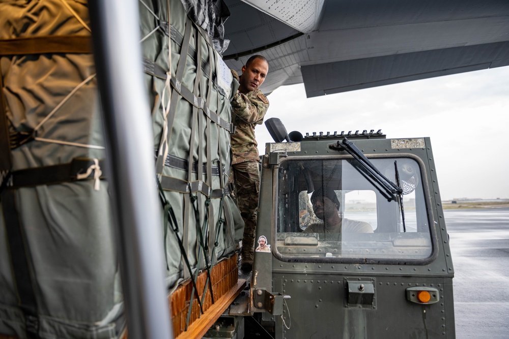 Airmen load AFCENT C-130s with humanitarian aid bound for Gaza