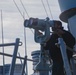 USS John S. McCain Sailor looks through the ship's binoculars