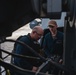 Sailors conduct maintenance on the 25mm gun