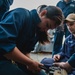 Sailor conducts maintenance on the 25mm gun