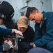 Sailors conduct maintenance on the 25mm gun